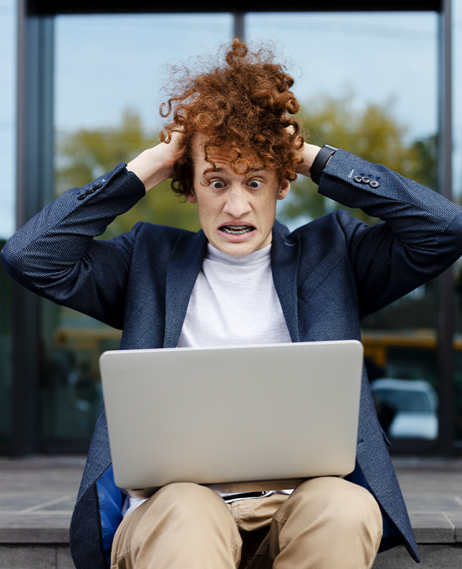 Business Owner Struggling with Website on Laptop